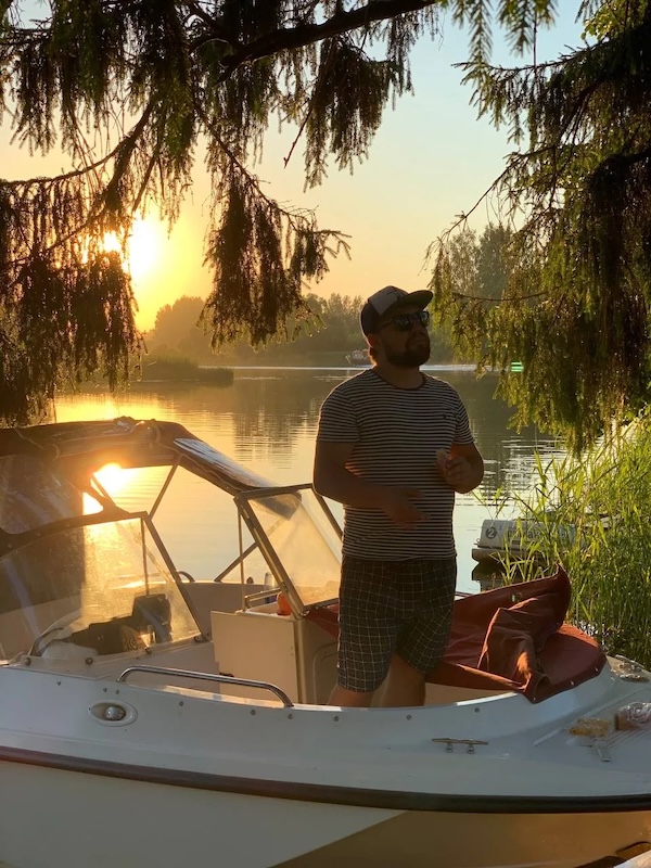 Daniil on a boat at sunset
