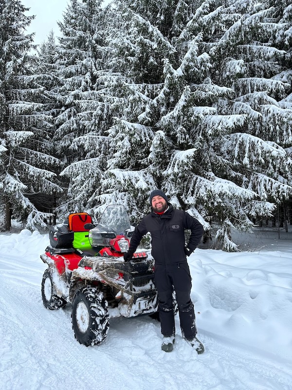 Daniil with snowmobile in winter
